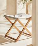 Taburete plegable de madera de teka con asiento de algodón de Zara Home
