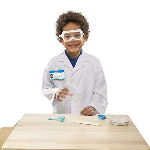 niño con disfraz de científico con bata blanca, gafas de protección, tubo  de ensayo y bigote, buscando tratamiento para el coronavirus Stock Photo
